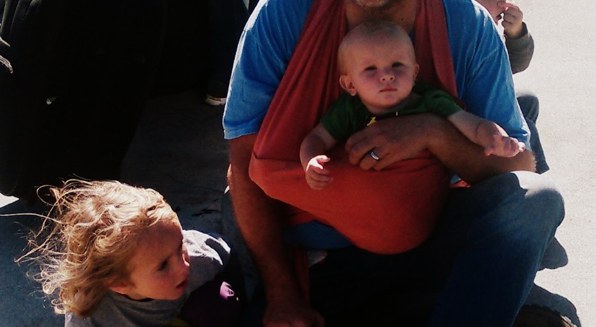 A baby in a wrap and toddlers in the wind... literally